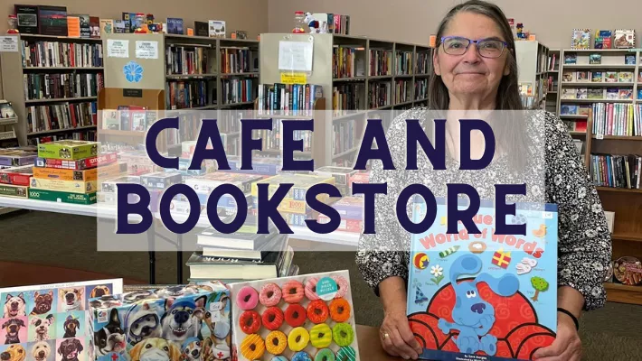 Customer of the bookstore showing off the childrens books and puzzles she bought